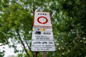 Paris, France - 20 mai 2025 : Panneau routier à l'entrée de la ville de Paris indiquant une zone à faibles émissions (LEZ ou ZFE), zone urbaine à accès restreint pour certains véhicules polluants.